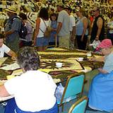 several ladies sitting around quilting at the Kutztown Festival