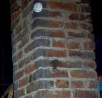 A clear ghostly orb caught on a chimney in the attic